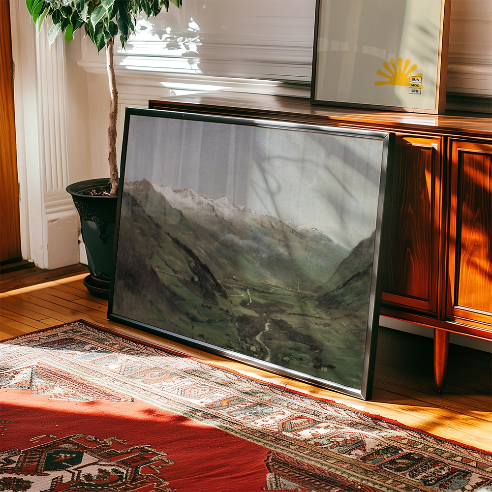A framed painting of a mountainous landscape resting against a wooden cabinet, with plants and a patterned rug in the foreground.