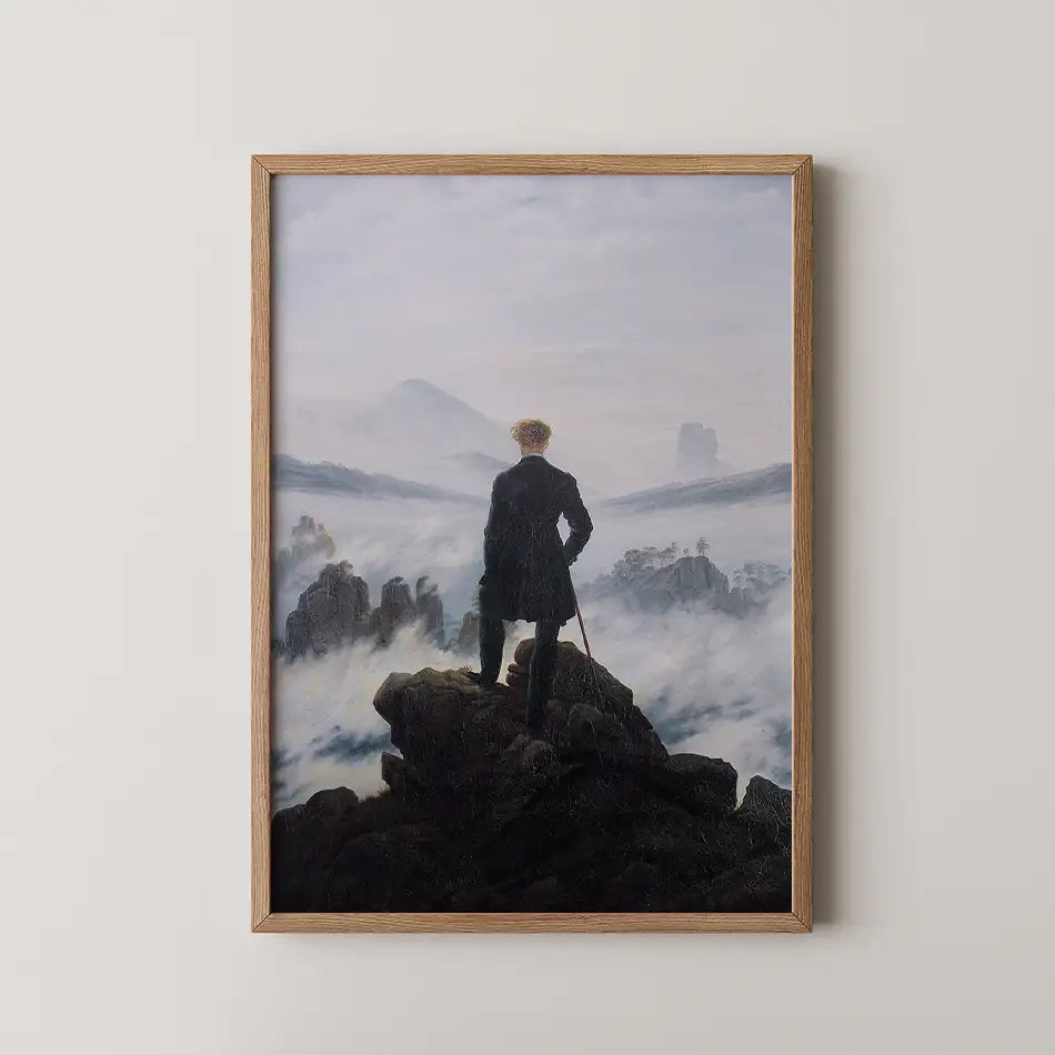 Framed painting of a solitary figure standing on a rocky outcrop, gazing over a misty landscape with distant mountains and a cloudy sky.