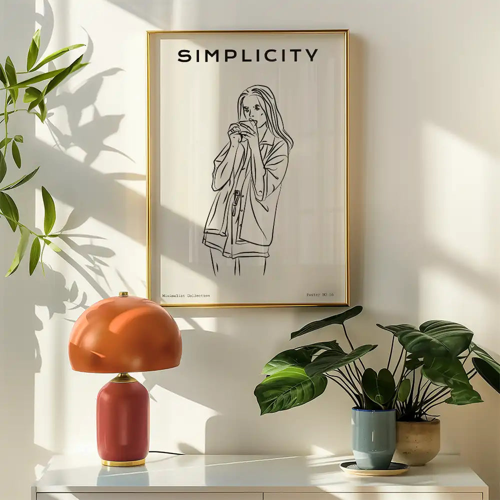 Modern minimalist poster featuring a stylish line drawing of a woman holding a cup, framed with a golden border, displayed in a bright room alongside indoor plants and a colorful lamp.