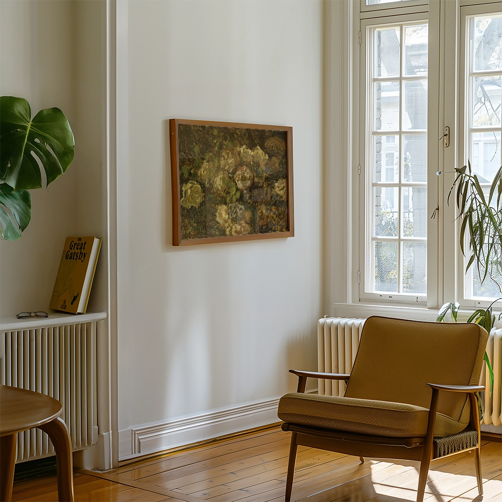 A painting with a floral design in a wooden frame, displayed on a white wall in a bright living room with a mid-century modern chair and a green plant.