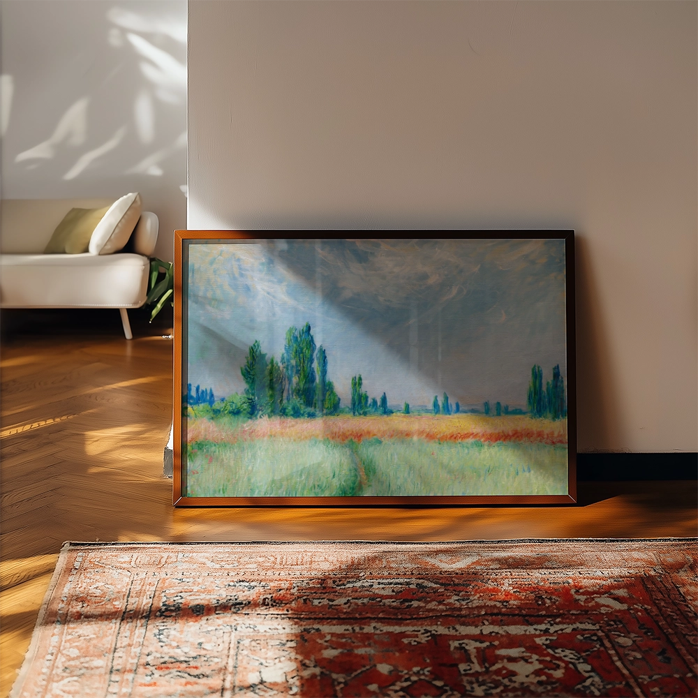 Framed landscape painting depicting a vibrant field with green trees under a cloudy sky, placed near a beige sofa and a patterned rug.