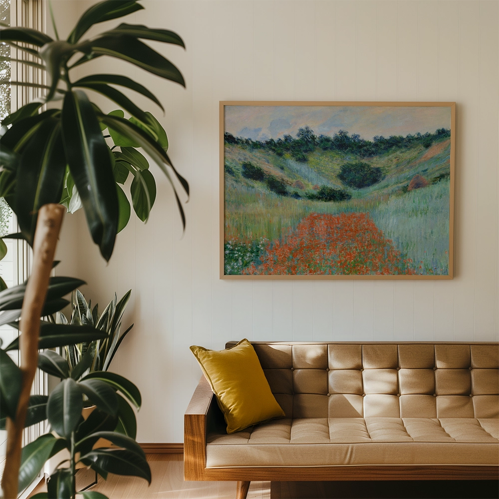 Painting of a vibrant landscape featuring rolling hills and a path adorned with orange flowers, framed and displayed above a modern wooden sofa with a yellow cushion.