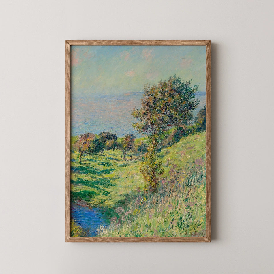 Painting of a serene landscape with trees and a tranquil body of water under a blue sky, framed in a Oak wood frame.