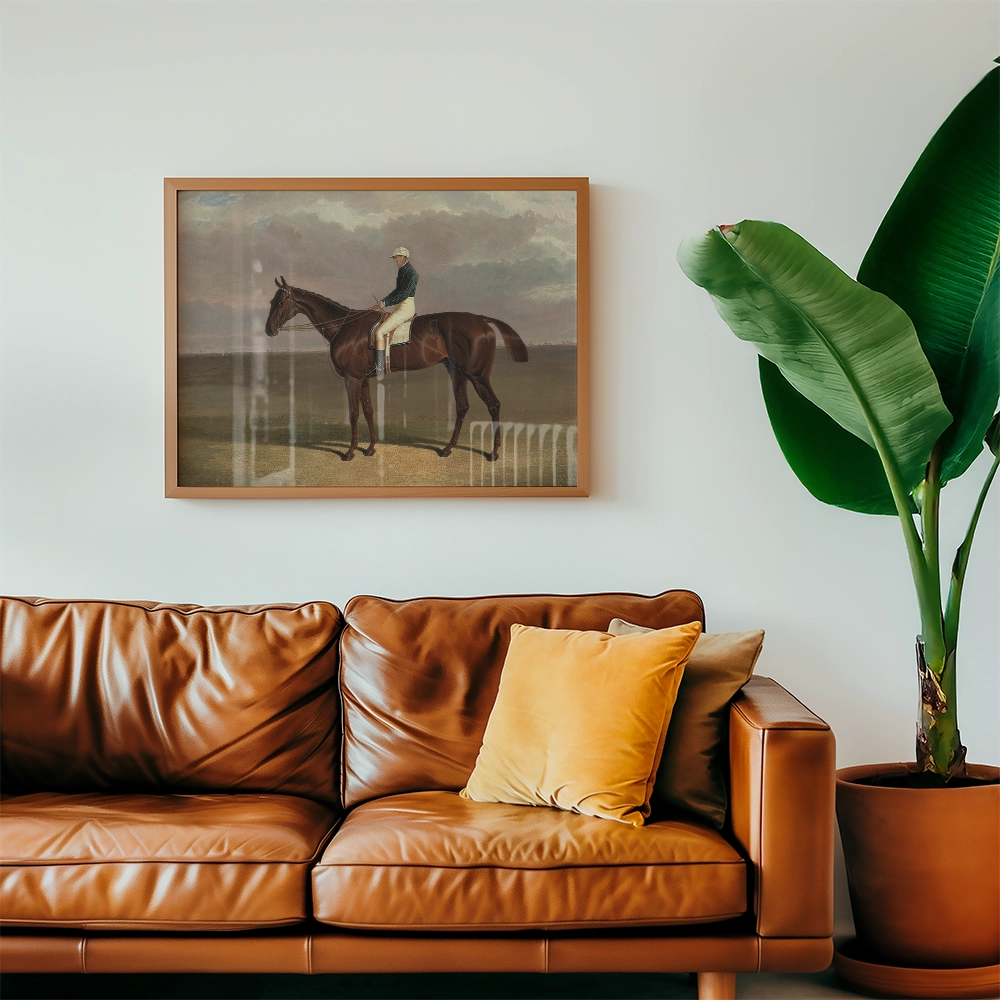 Framed painting of a rider on a horse hanging above a brown leather sofa in a modern living room setting.