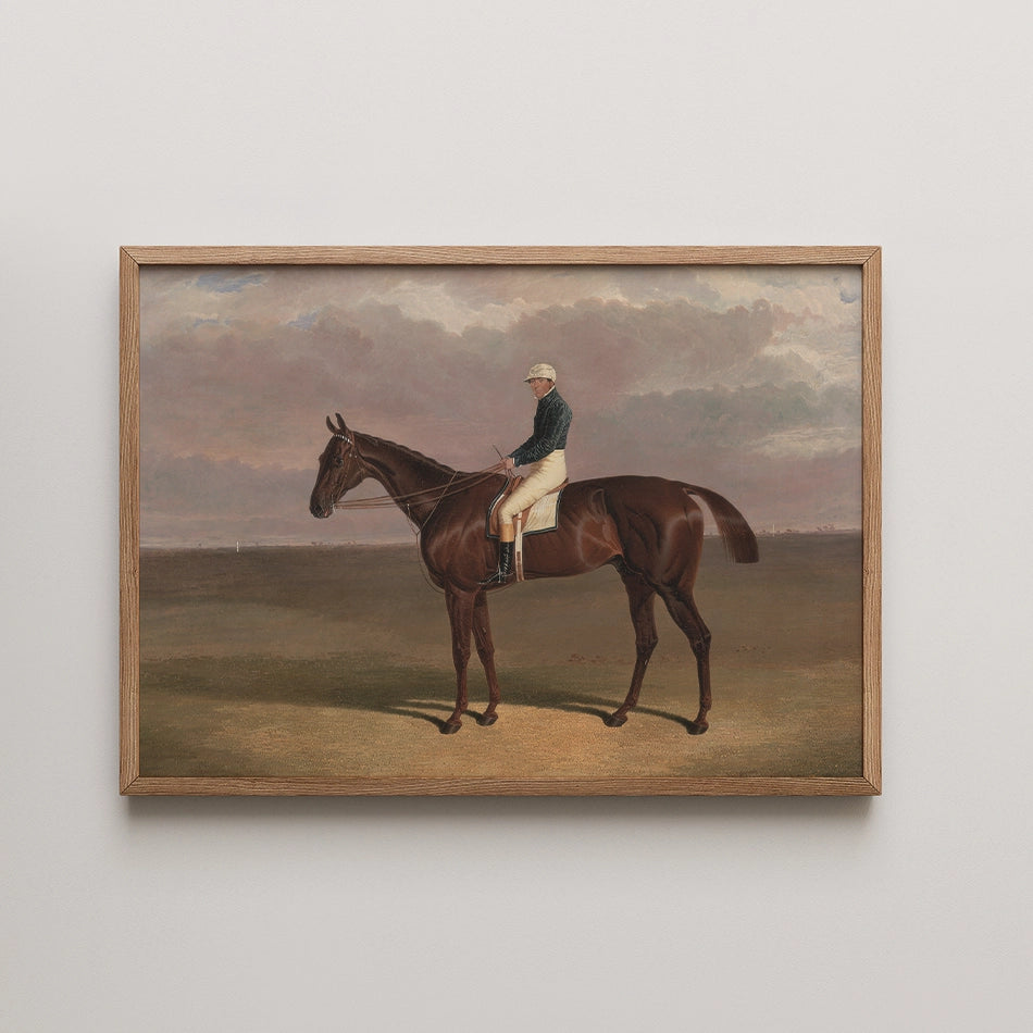 Framed painting of a horse rider in a landscape, featuring a brown horse and a rider in traditional attire against a cloudy sky.