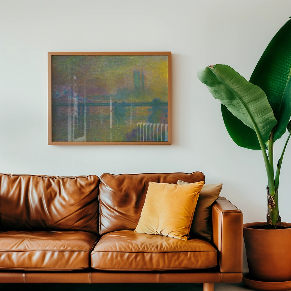 Framed abstract painting hanging above a brown leather sofa with a yellow pillow, next to a large green plant.