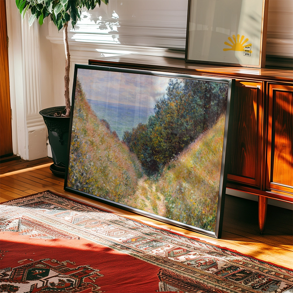 Framed landscape painting leaning against a wooden cabinet, with vibrant hues and visible brush strokes, surrounded by indoor greenery and a decorative rug.