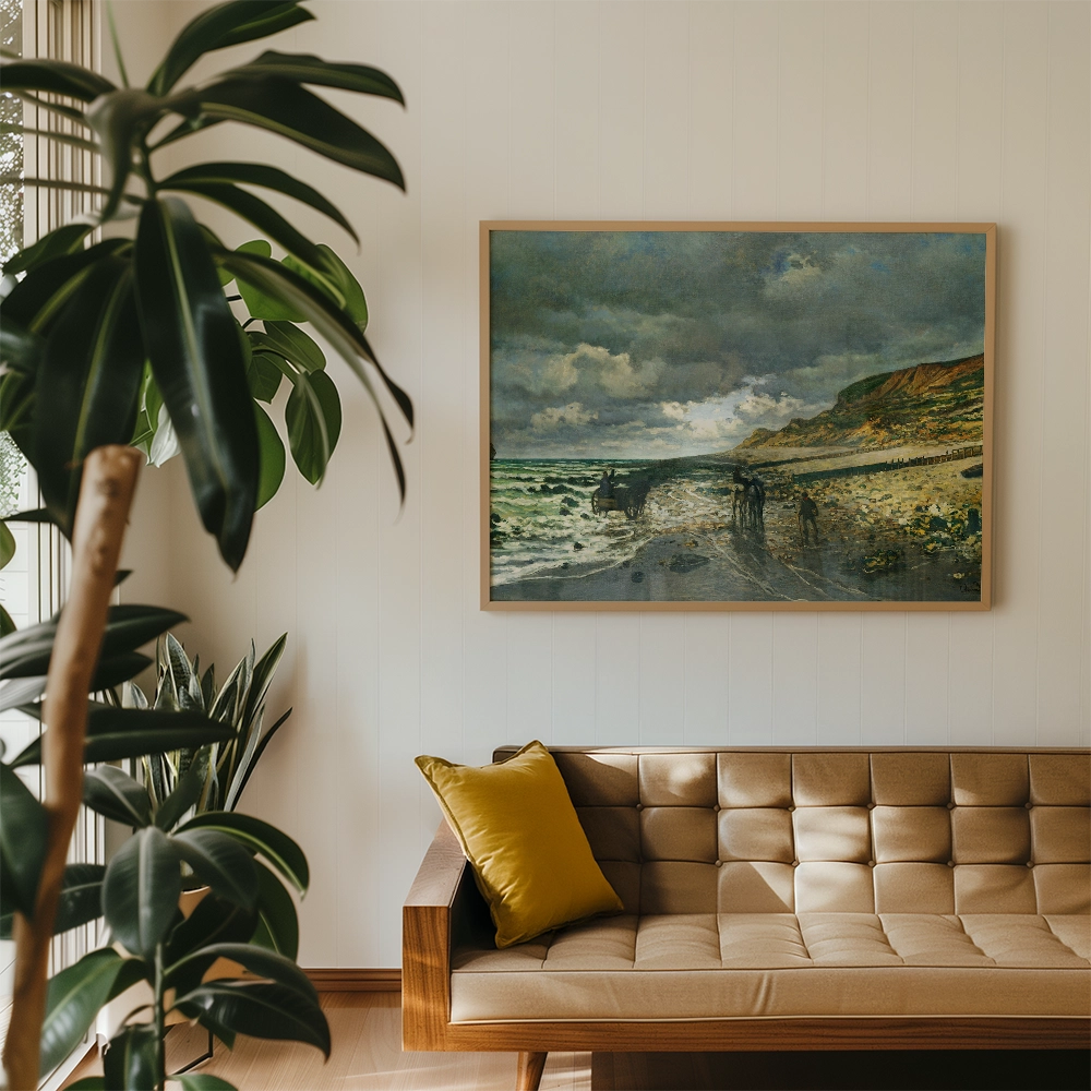 Framed coastal landscape painting depicting figures by the shore, displayed above a modern beige sofa in a bright living room setting with plants.