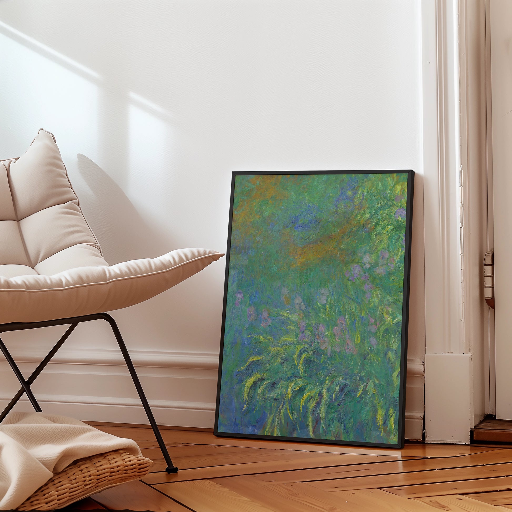 Framed painting with abstract green and purple floral design leaning against a wall next to a modern chair.