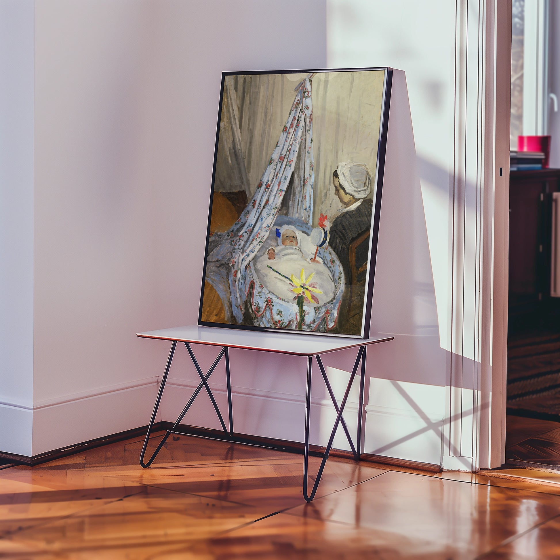 Painting of a mother and child in a nursery setting displayed on a modern folding table in a sunlit interior.