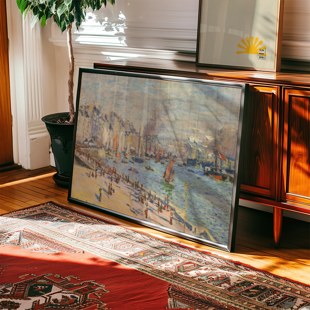 Framed painting of a seaside scene with boats and people on the shore, leaning against a wood cabinet in a sunlit room.