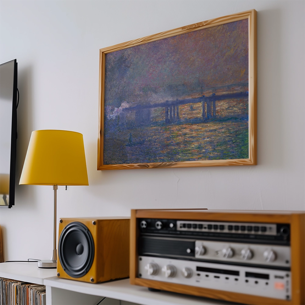 A colorful painting in a wooden frame hanging on a wall, accompanied by a yellow lamp and vintage audio equipment.
