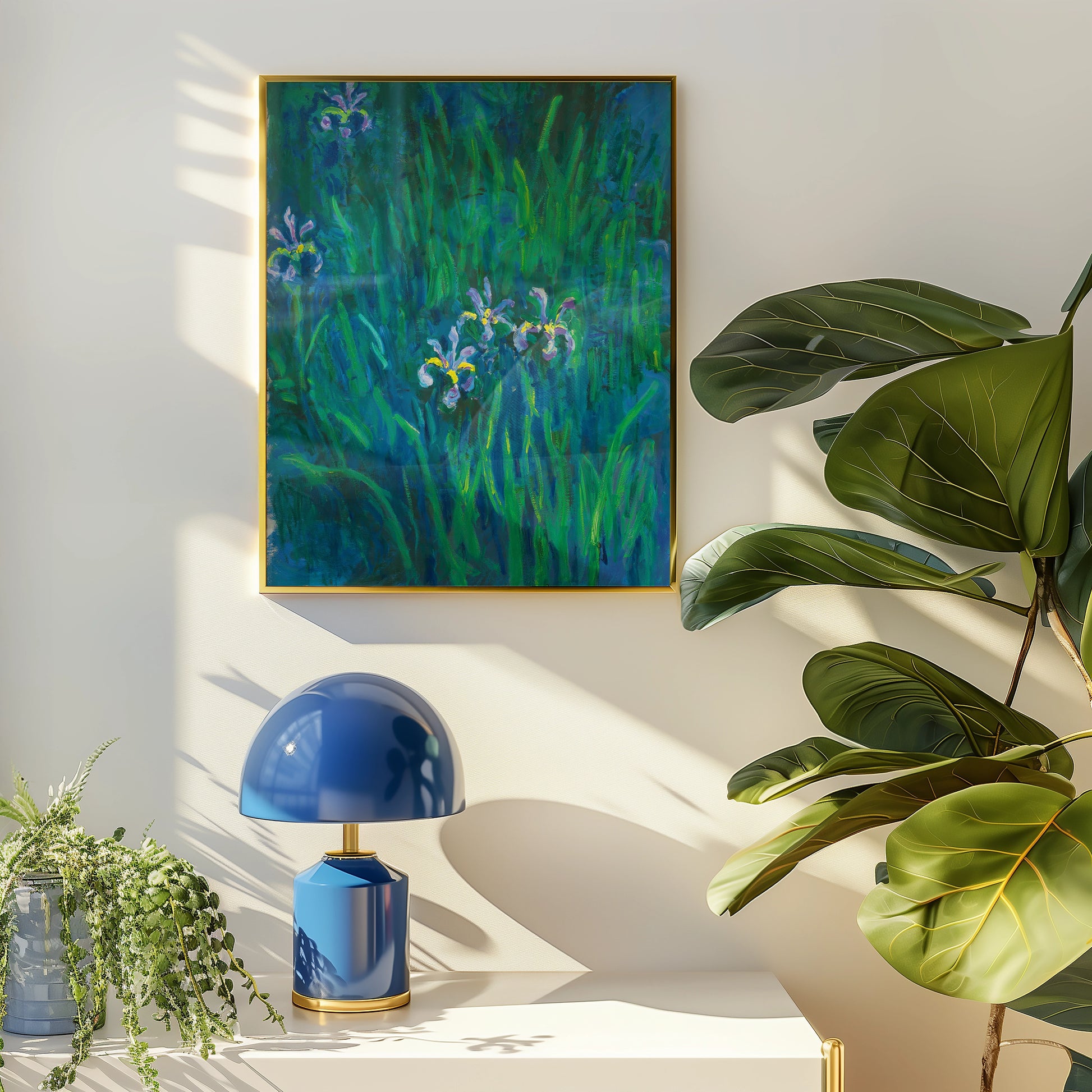 Painting of irises in vibrant green grass, framed and displayed on a wall beside a decorative blue lamp and a potted plant.