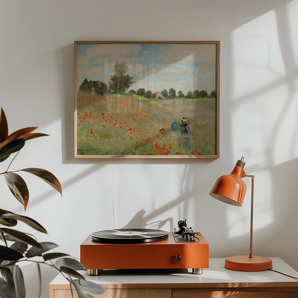 Framed painting of a landscape with poppies and figures, displayed above a stylish orange record player and lamp in a modern interior setting.