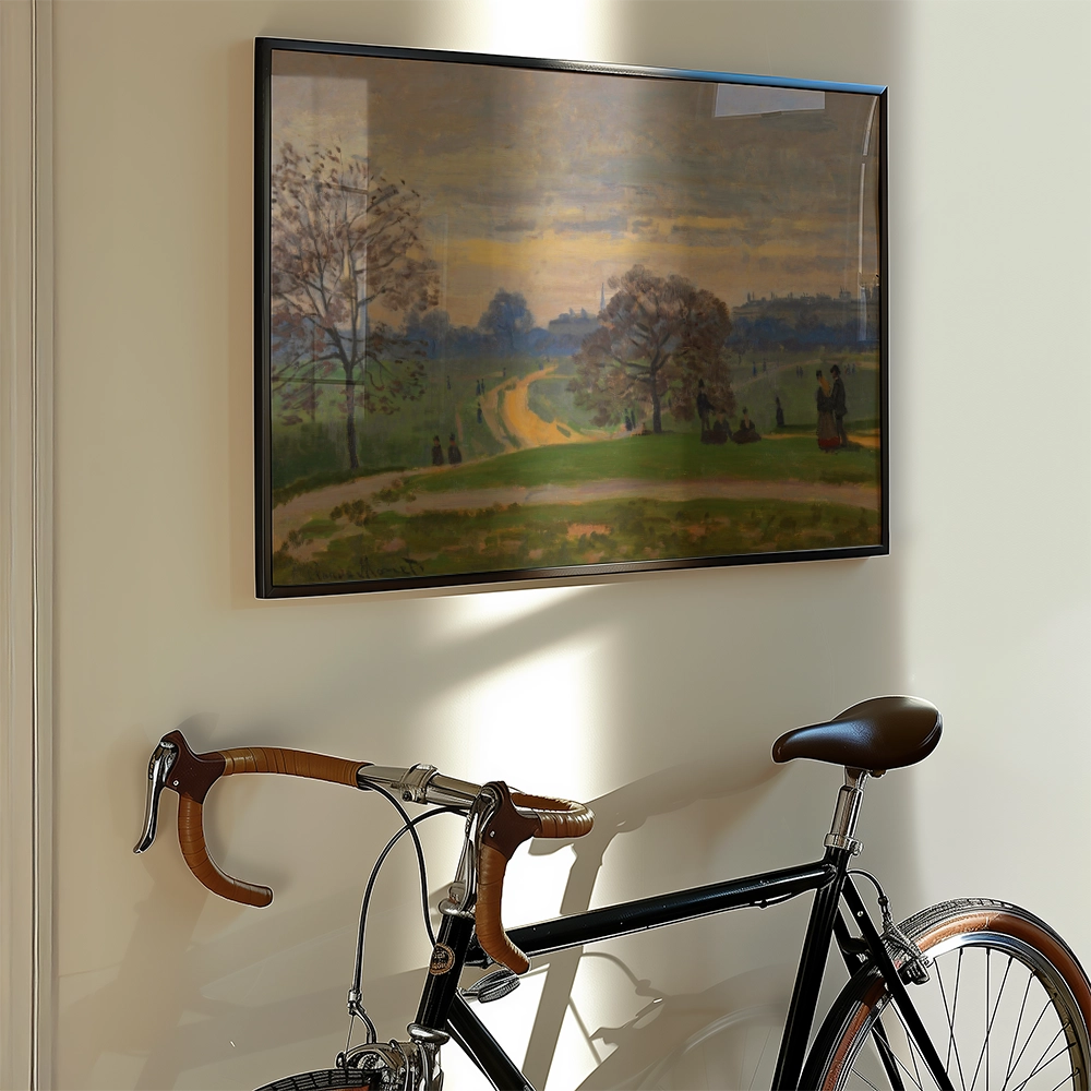 A vintage landscape painting in a black frame hanging on a wall next to a classic bicycle with brown accents.
