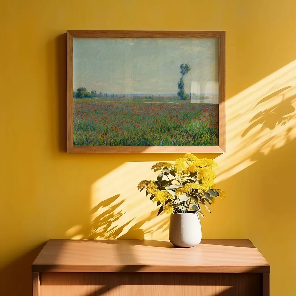 Framed painting of a colorful field with a single tree, hanging on a yellow wall above a wooden console table adorned with a vase of yellow flowers.