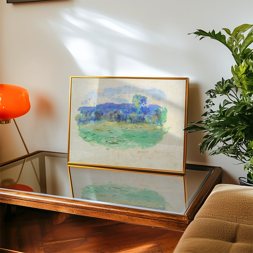 Painting in a gold frame depicting a serene landscape with green and blue hues, placed on a glass-top coffee table beside a plant and an orange lamp.