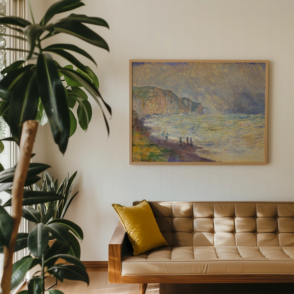 Painting of a coastal scene with people by the shore, framed and hanging on a wall above a modern sofa with a yellow decorative cushion, surrounded by indoor plants.