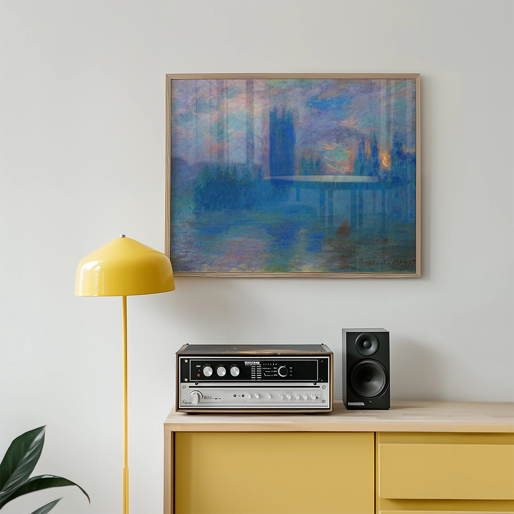 Framed painting of a serene landscape with a bridge, displayed above a yellow lamp and a vintage stereo system on a wooden cabinet.