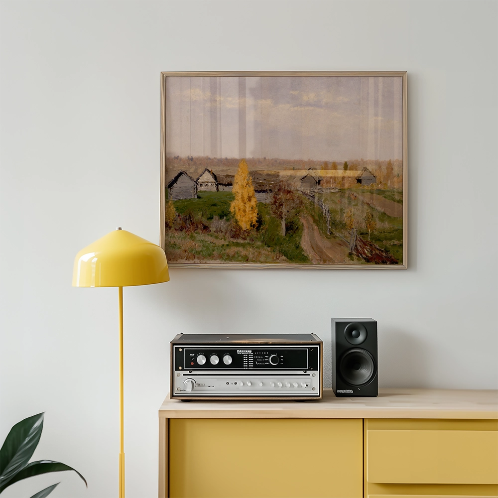 Landscape painting with autumn trees and rustic houses displayed above a mid-century modern audio system and a yellow floor lamp in an elegant living room setting