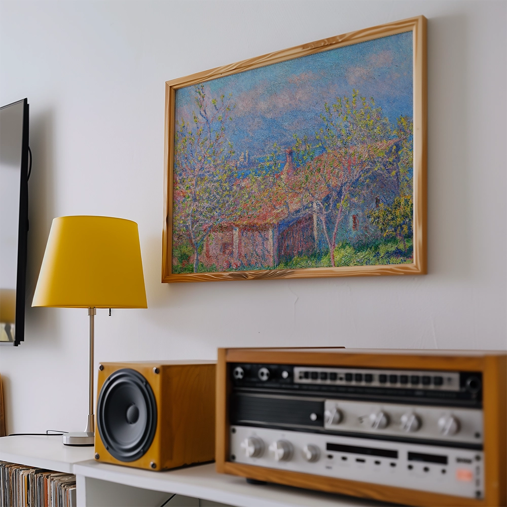 Painting of a rustic landscape with trees in a wooden frame, displayed on a wall above a yellow lamp and a vintage sound system.