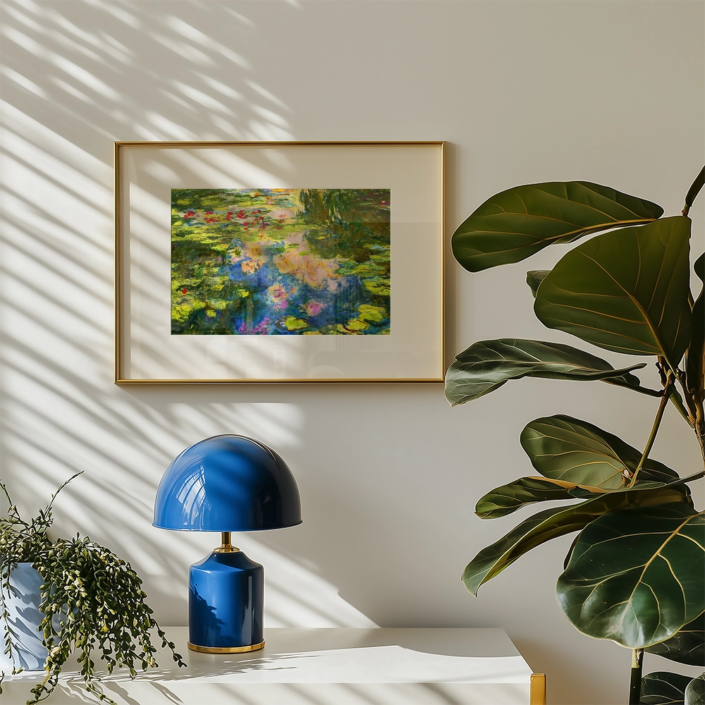 Framed painting of a water lily pond by Claude Monet, displayed on a beige wall with a blue lamp and potted plant in the foreground.