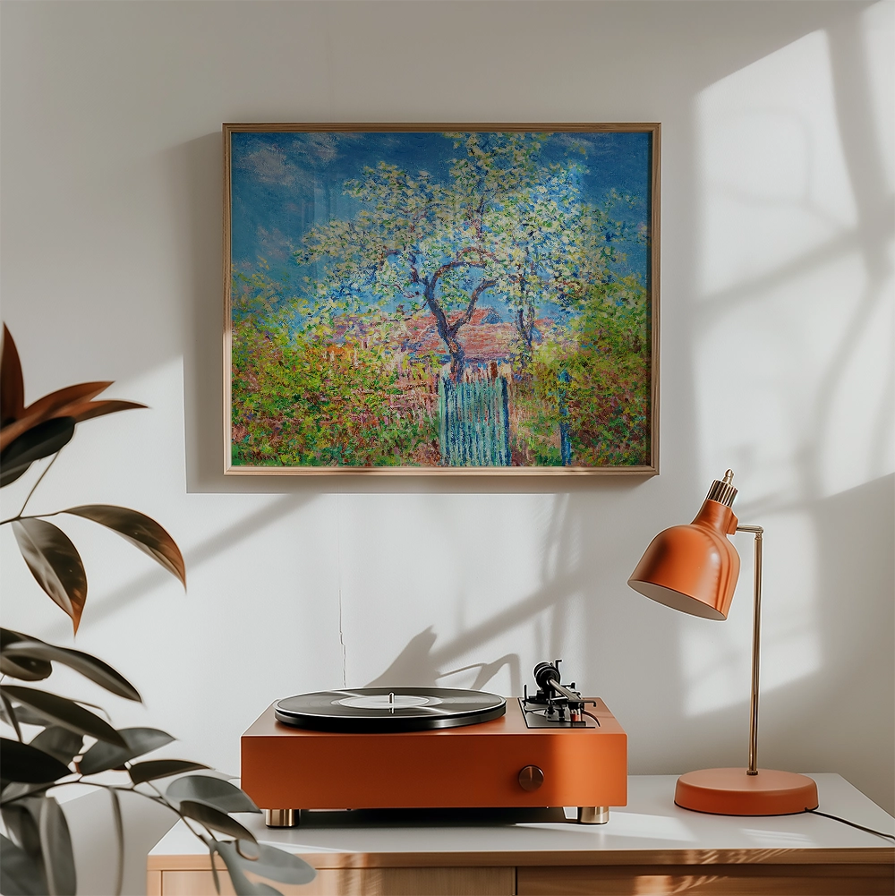 Painting of a vibrant landscape with a blue sky, green trees, and a wooden fence, displayed above a retro record player and an orange desk lamp in a cozy interior setting.