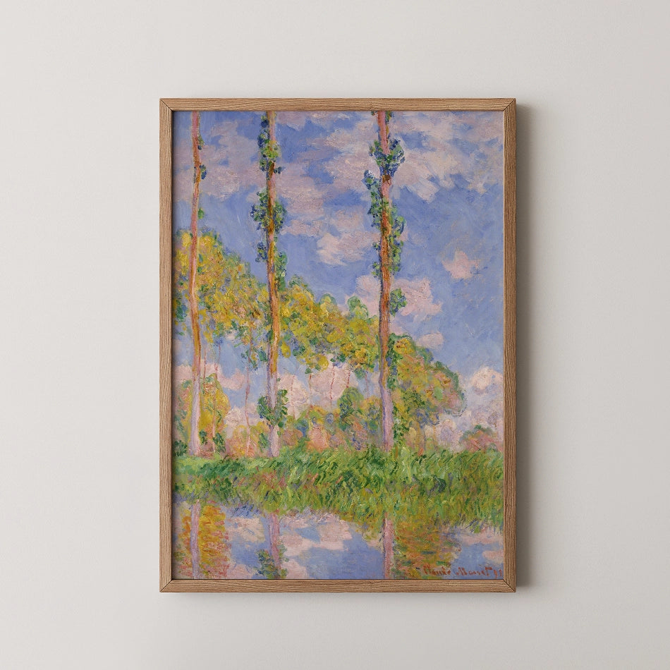 Framed painting of trees against a blue sky with fluffy clouds, reflecting in a body of water.
