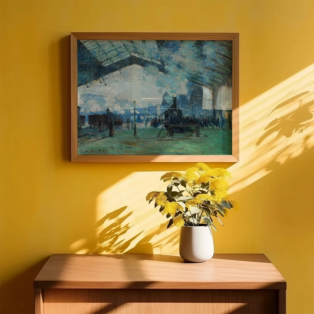 Framed painting of a bustling indoor scene with people and vintage carriages, displayed on a bright yellow wall above a wooden cabinet with a vase of yellow flowers.