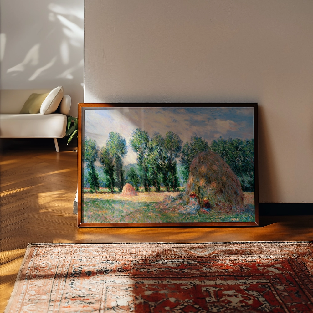 Framed painting of a serene landscape featuring haystacks and green trees, displayed in a stylish indoor setting.