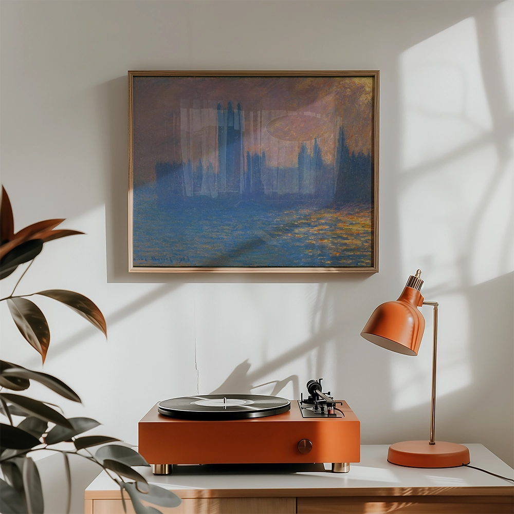 Painting in a gold frame depicting a serene blue landscape with a record player and modern orange lamp in a bright, minimalistic room.