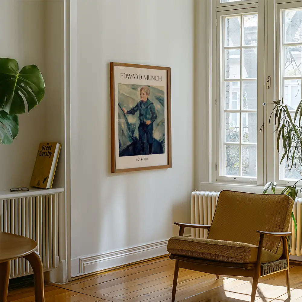 Painting titled "Boy in Blue" by Edward Munch displayed on a wall in a bright room with a chair and a potted plant.