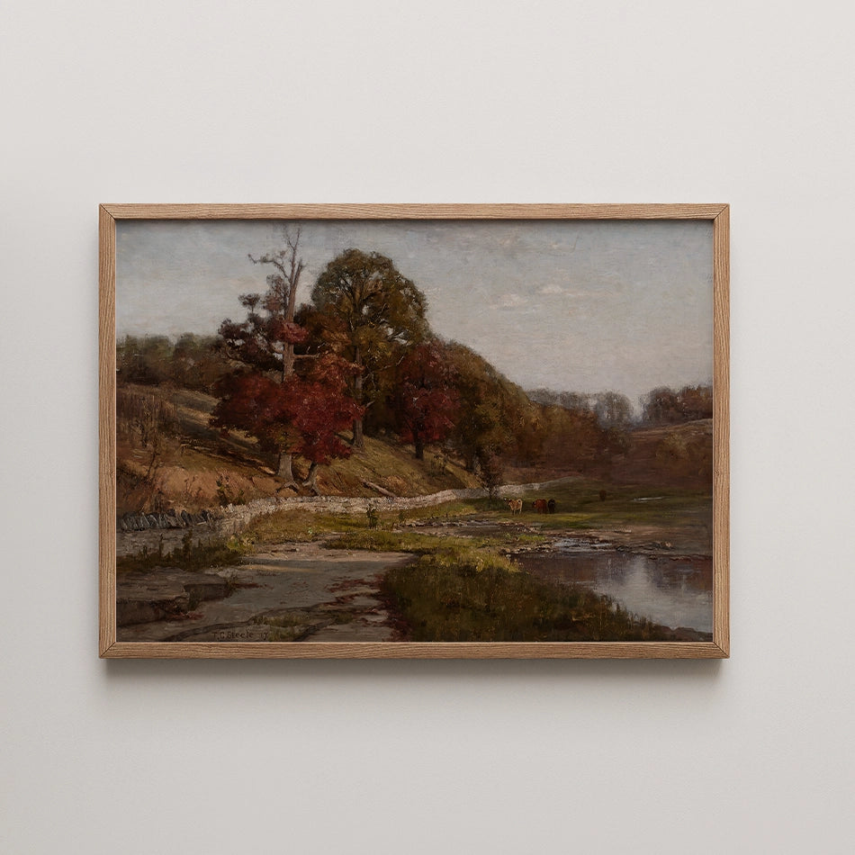 Landscape painting featuring a serene river scene with trees in autumn colors, framed in light wood.