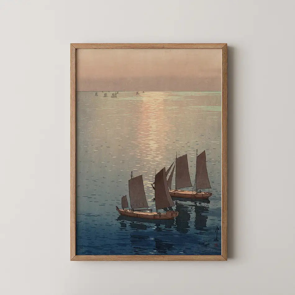 A serene painting of three sailboats on calm waters, framed in light wood, with a soft pastel sky reflecting on the surface.