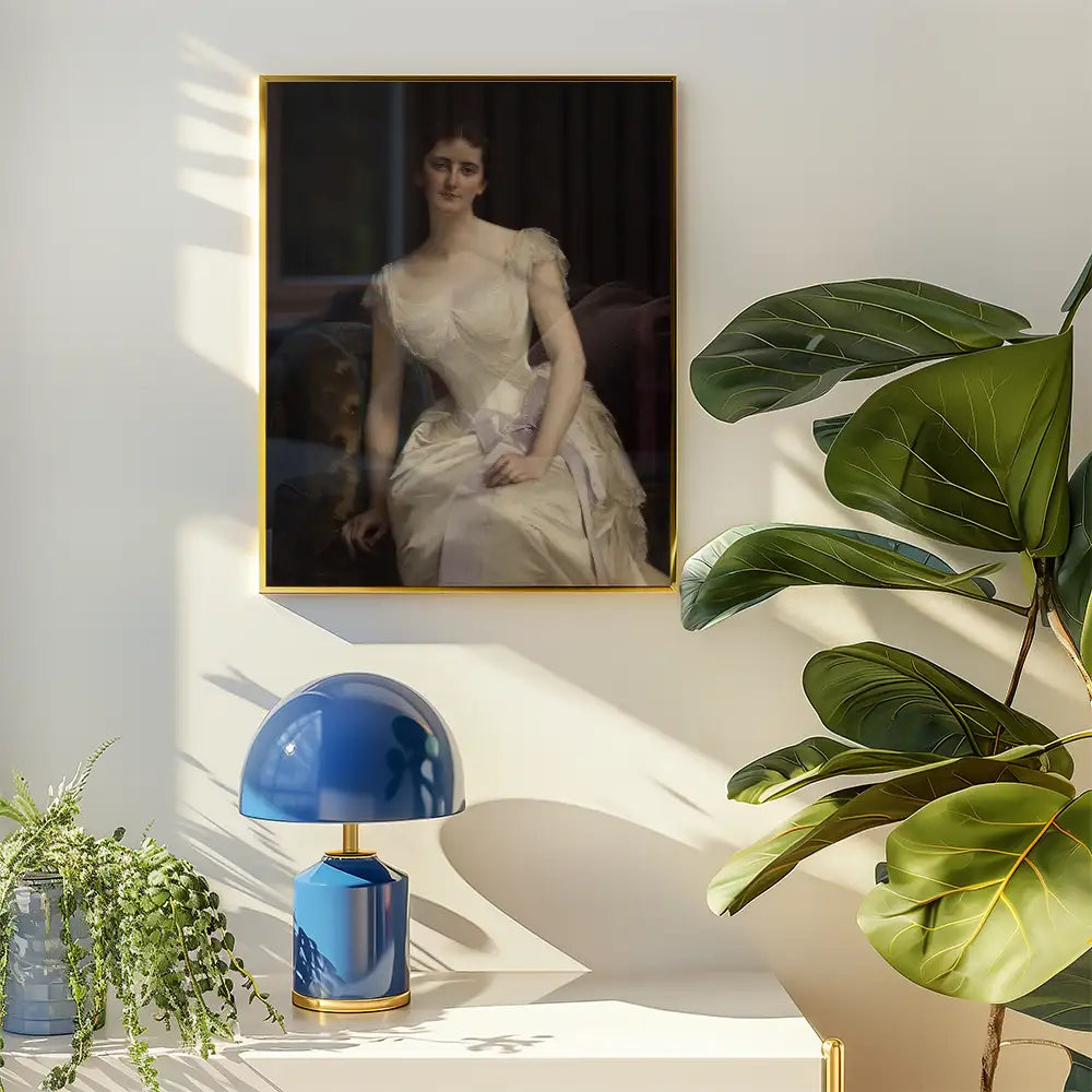 Painting of a seated woman in a white gown, framed and hung on a wall above a lamp and potted plant.