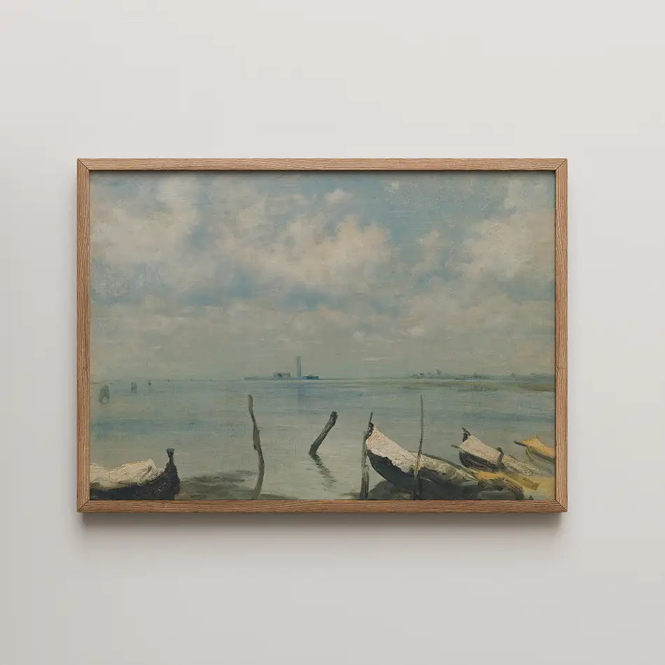 A serene landscape painting featuring calm waters, wooden boats, and a cloudy sky, framed in natural wood.
