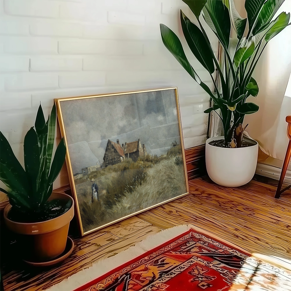 Painting of a rural landscape featuring a farmhouse surrounded by grass, displayed near potted plants in a cozy interior setting.