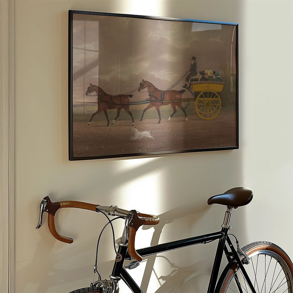 Painting of two horses pulling a carriage with passengers, framed and hanging on a wall beside a vintage bicycle.