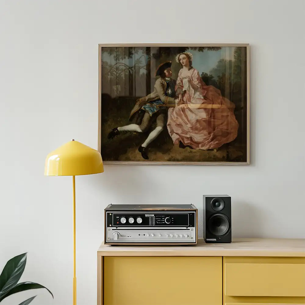 Framed painting of a couple in an intimate pose against a forest backdrop, displayed on a light wall above a yellow lamp and audio equipment on a wooden dresser.