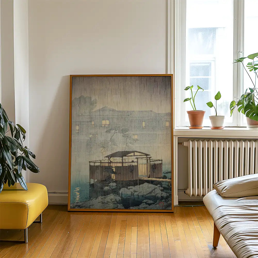 Framed painting of a serene water scene featuring a cabin in the rain, displayed in a cozy living room setting with plants and a modern yellow sofa.