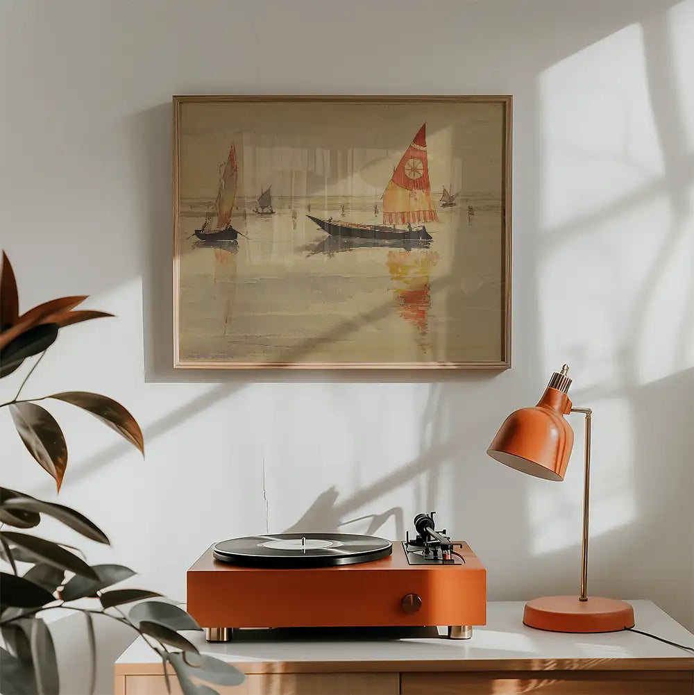 Framed painting of sailboats on the water above a modern orange turntable and lamp in a bright room.