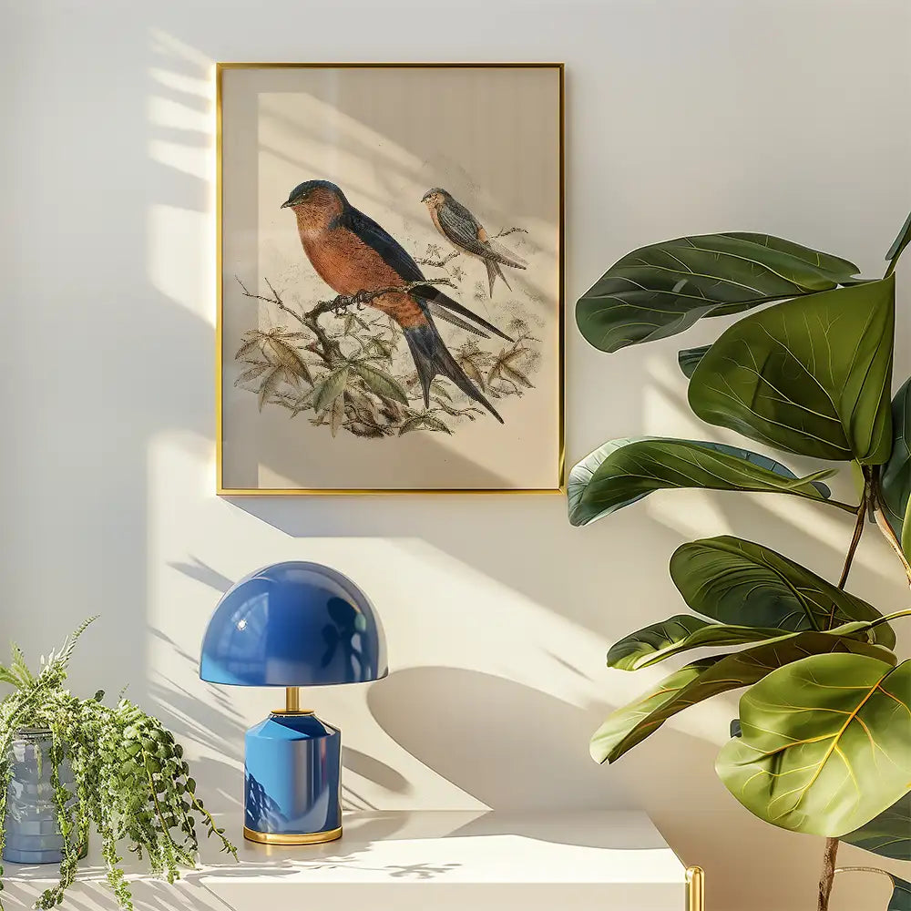 Vintage-style bird painting in a gold frame, displayed on a wall beside a blue lamp and a leafy plant.
