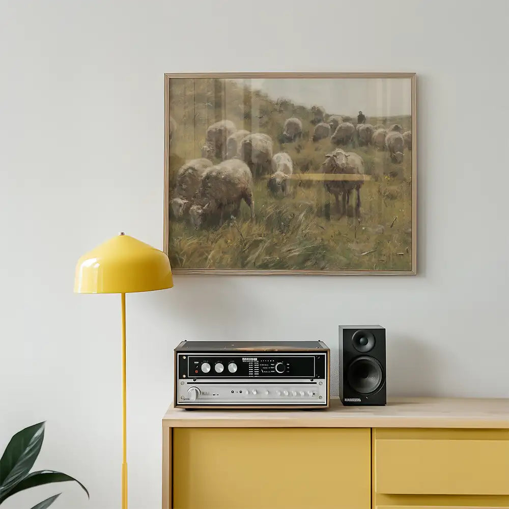 Painting of sheep in a grassy landscape displayed above a vintage speaker and a yellow floor lamp in a modern room setting.