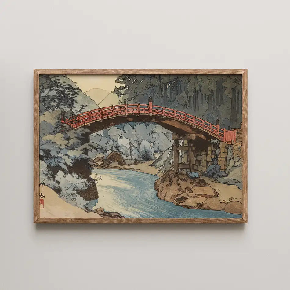 A framed painting depicting a serene landscape with a red bridge over a gently flowing river, surrounded by trees and rocks.