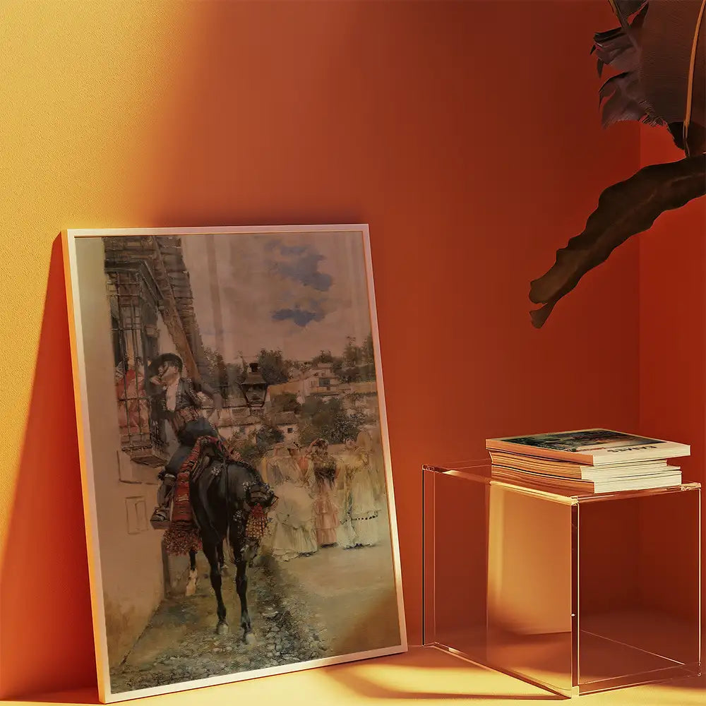 Framed painting of a person on a horse in an old town setting, displayed against an orange wall with a side table holding stacked books.