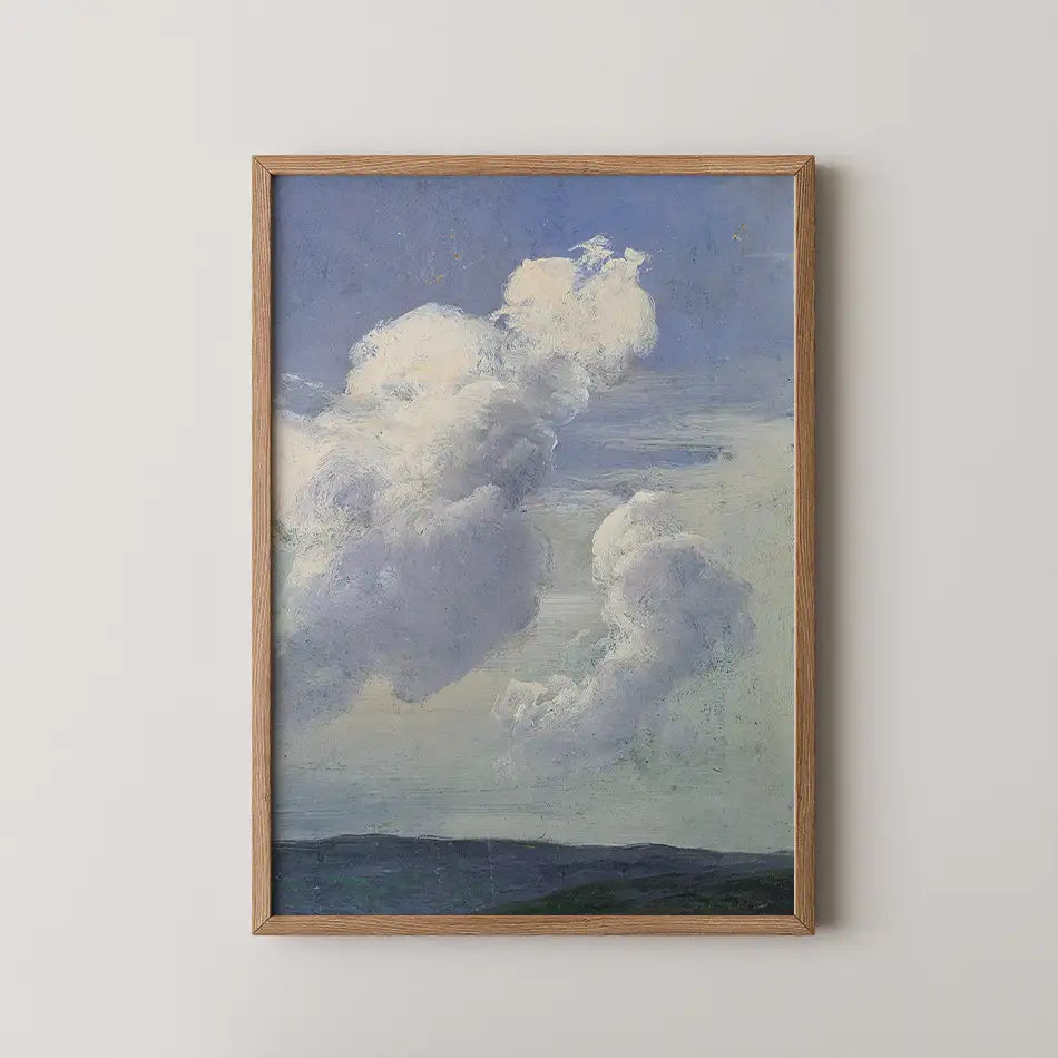 Painting of a serene sky with fluffy white clouds and a hint of rolling hills, framed in wood.