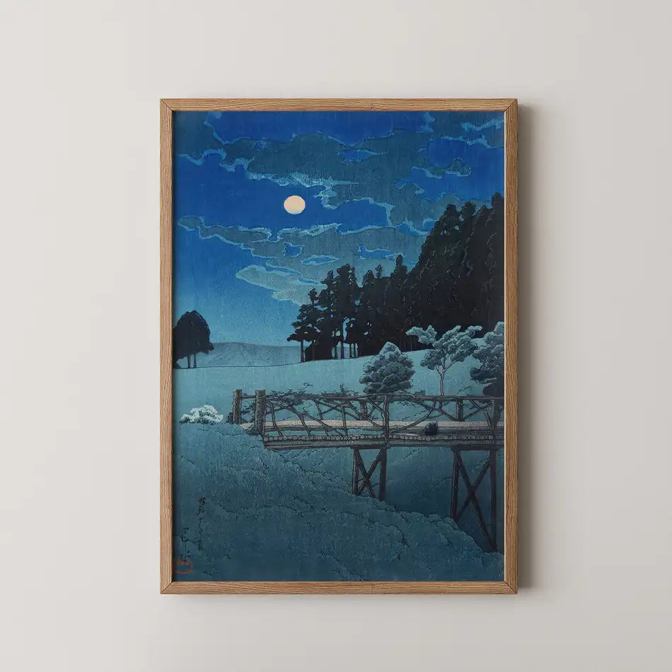 Moonlit landscape painting featuring a wooden bridge, trees, and a starry sky, framed in natural wood.