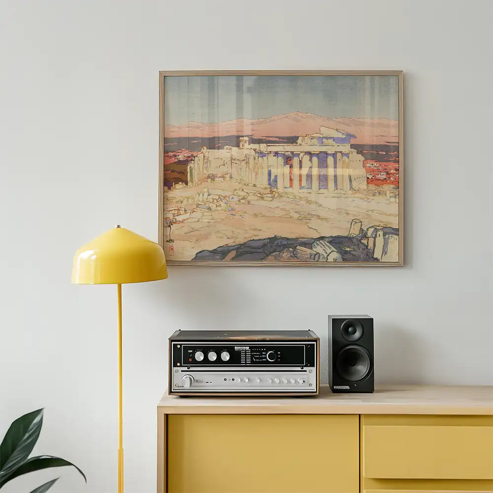 Painting of ancient ruins hanging above a yellow lamp and a vintage audio system on a yellow sideboard.