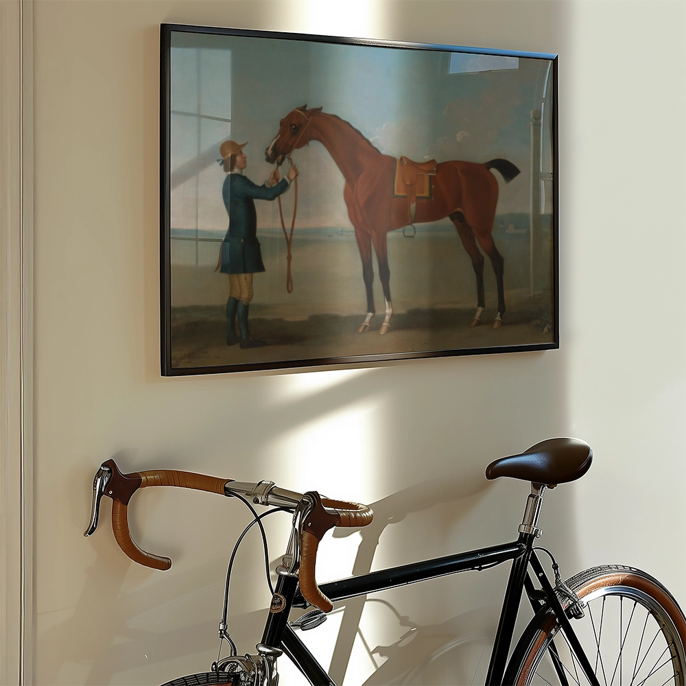 Painting of a man holding a brown horse, displayed above a bicycle against a light-colored wall.