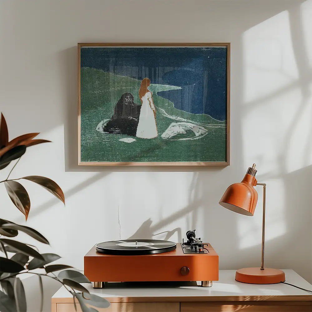 A framed painting of a woman in a white dress standing beside a dark figure on a green landscape, displayed above an orange record player and lamp on a light wood table.